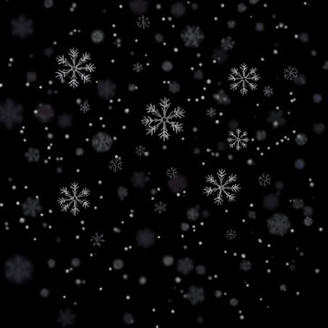 Snow flakes falling on black background. Winter weather