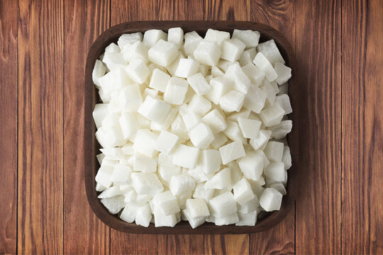 coconut cubed in square plate on wooden table background. vegetarian organic food for healthy diet.