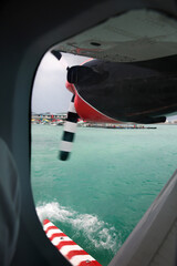 Naklejka premium Seaplane Window View Over Maldives Turquoise Lagoon and Resort