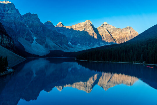 Sunrise over Lake Moraine with mountain reflections in Alberta Canada