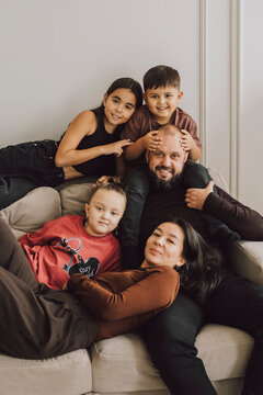 Happy family relaxing together on couch showing unity and togetherness