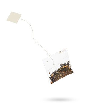 Filter tea bag with blanck label floating, isolated on white background.