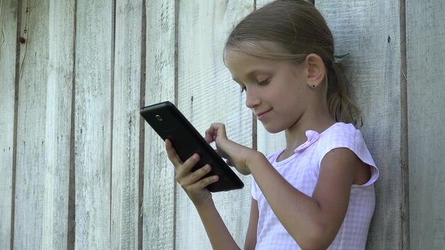 Child Playing Tablet Outdoor, Rural Kid Browsing Smartphone, Rustic Young Girl Searching Internet Online