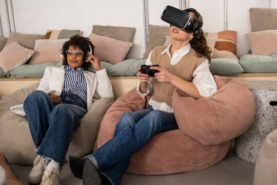 Business team collaborating in modern office with virtual reality and gaming