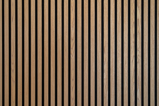 Sound dampening acoustical panels detail of a wooden wall. Wooden wall texture with wood acoustic panels