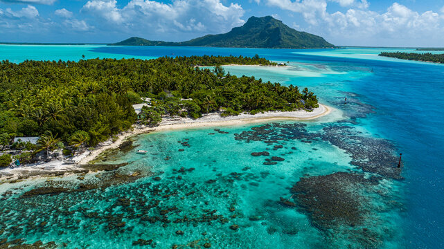 Aerial view of tropical islet and lagoon in Maupiti Society Islands