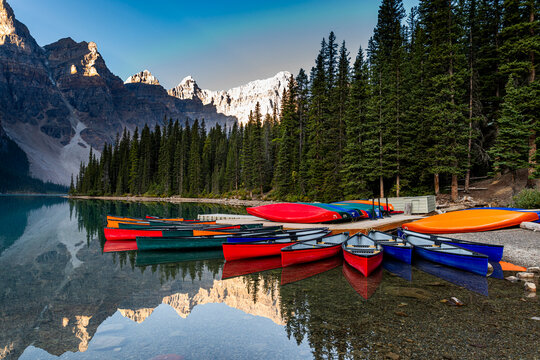 Colorful canoes at sunrise on Lake Moraine in Alberta Canada