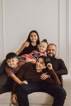 Happy family relaxing together on a couch at home