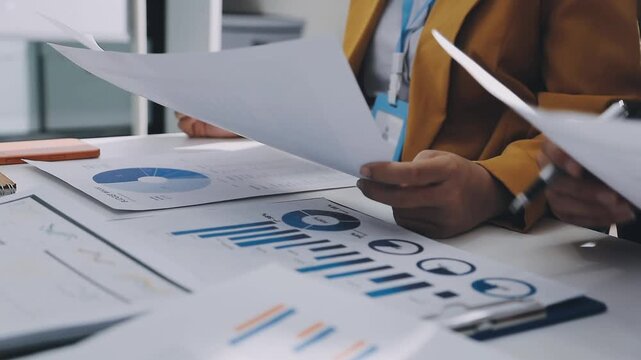 Business woman accountant working in office checking financial accounts and allocating company budgets.
