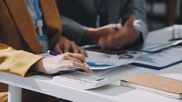 Business woman accountant working in office checking financial accounts and allocating company budgets.