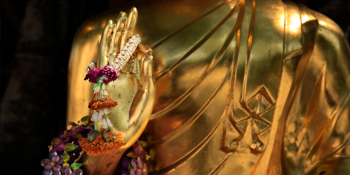 Detail hand of a statue of buddha, in buddhist temple ,with golden color