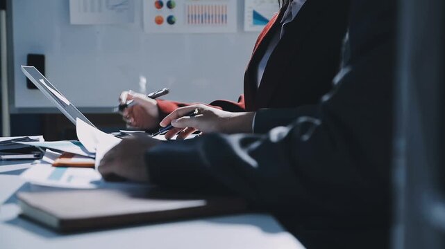 Business woman accountant working in office checking financial accounts and allocating company budgets.