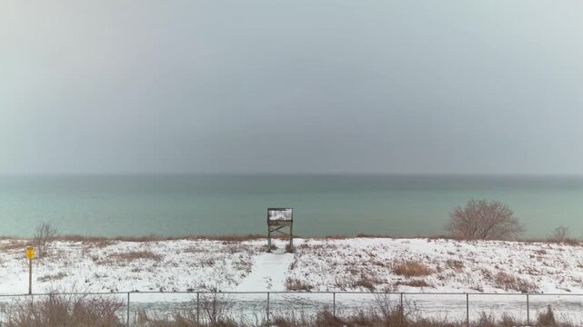 Aerial Drone Over Winter Snowy Coastline at Dawsons Point in Courtice Ontario Canada, Dolly Shot