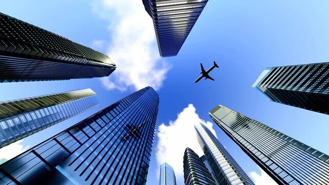 Dynamic low-angle shot of sleek skyscrapers against a blue sky with clouds, featuring an airplane flying above, evoking urban dynamism and modern architecture.