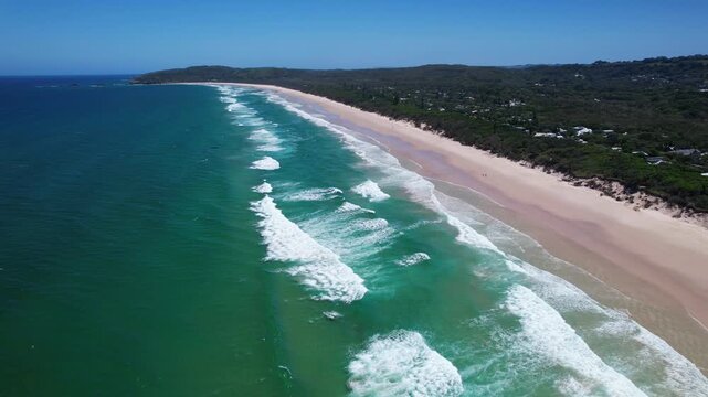 Waves With Long White Sand Shores Of Tallow Beach In Byron Bay, New South Wales, Australia. Aerial Drone Shot