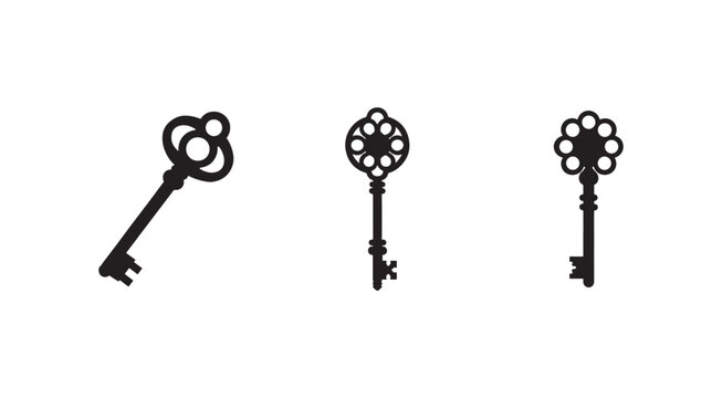 Three antique skeleton keys with ornate floral designs on the head isolated on white background