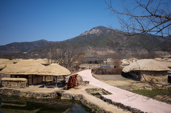 Curved pathway and traditional village with waterwheel in Nagan Eupseong, South Korea