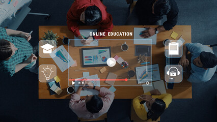 Diverse group in a modern workspace engaged in online education, utilizing digital tools and...