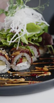 Close-up of Fusion Sushi Rice Roll Topped with Fresh Vegetables and Herbs