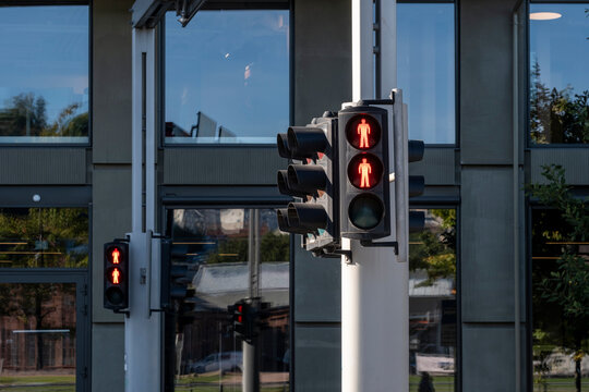 Pedestrian crossing signal with red traffic light on urban facade showing regulation and safety for walking control at street intersections