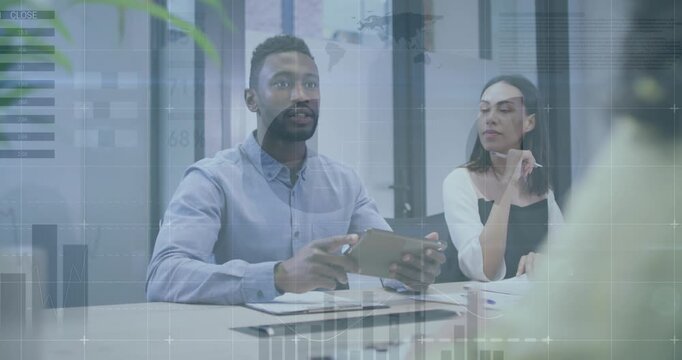 Business executive using tablet showing charts while peer nodding shaking hands sealing agreement