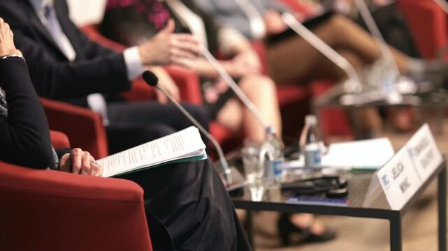 Political or business conference with roundtable and panel discussion, public speaking engagement, corporate seminar, professional networking event with microphones and expert speakers
