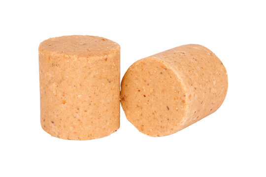 Two pacoca, a traditional Brazilian peanut candy, isolated on a white background