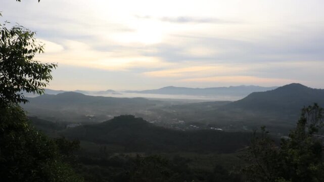 Natural video background of a high-angle atmosphere on a mountain that overlooks the surrounding scenery(mountains, trees,sea)from a scenic vantage point,with a wooden chair for sitting and resting