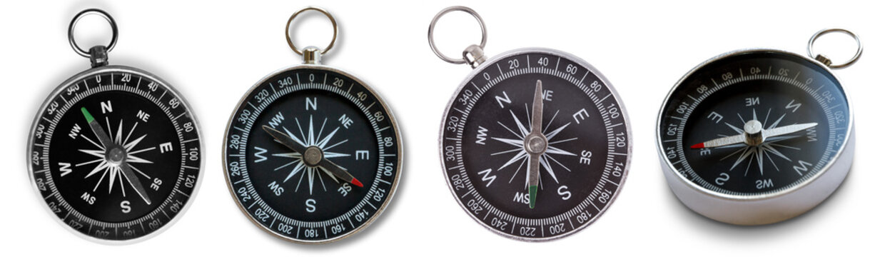 Collection of vintage and modern compasses, displaying magnetic needles pointing north.