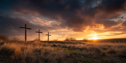 Obraz premium Three wooden crosses at sunset during Semana Santa in rural field with dramatic sky and golden light