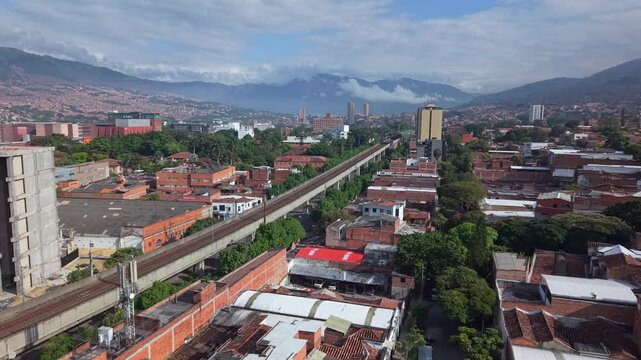 Aerial view of Medell&iacute;n, highlighting Metro and lush urban landscape