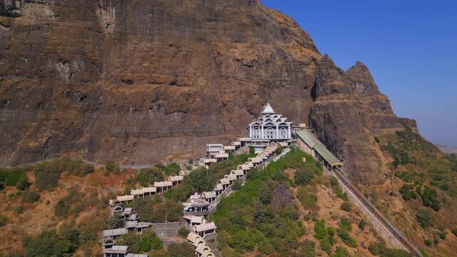 Orbit drone shot of Saptashrungi Devi Temple, one of Maharashtra&rsquo;s sacred Sadetin Shakti Peethas, capturing the hilltop shrine, surrounding mountains and vibrant pilgrimage atmosphere in Vani, Nashik