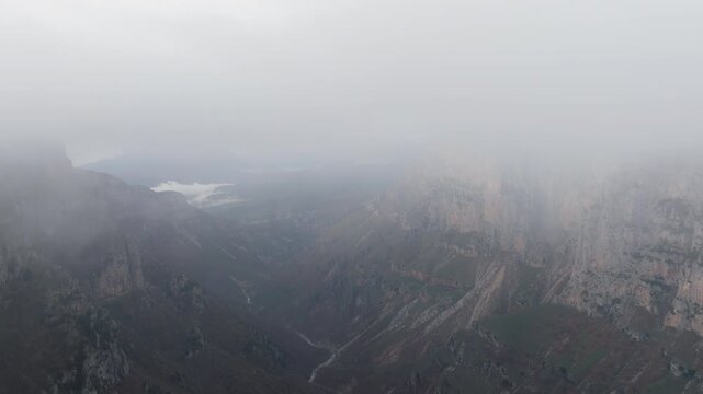 Vikos Gorge Pindus Mountains Epirus rocky landscape featuring steep cliffs and misty clouds