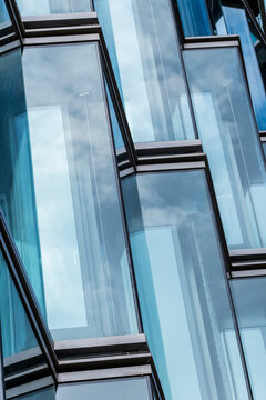 Modern corporate office windows with crisp frames on a glass facade forming geometric abstract pattern for business architecture background and design layouts