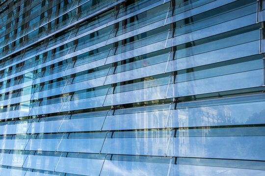 Modern glass panel facade with clean lines forming abstract corporate architecture texture pattern for business branding backgrounds and office exterior design concepts