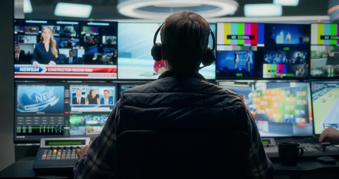 Backstage TV Station Production Control Room Shows a Male Technician Routing Multiview Sources, Switching Live Politics, Economy, Industry and Entertainment Segments.LIVE Broadcast.