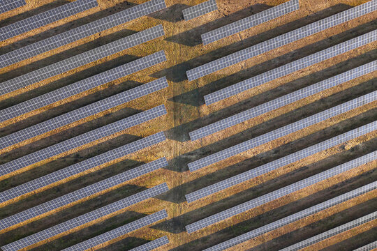 Aerial view of rows of solar panels stretch across the landscape, catching the sunlight, an energy farm, Wizna, Podlaskie Voivodeship, Poland.