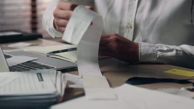 Frustrated worried Caucasian business man reading bill paperwork in office stressed male CEO working checking documents financial problem tax payment debt expense headache businessman crisis desk work