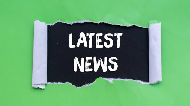 Latest news message writing on ripped torn paper background