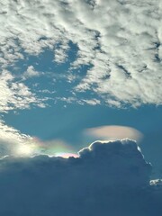 Fototapeta premium Beautiful iridescent pileus cloud with spectral colors in the summer sky