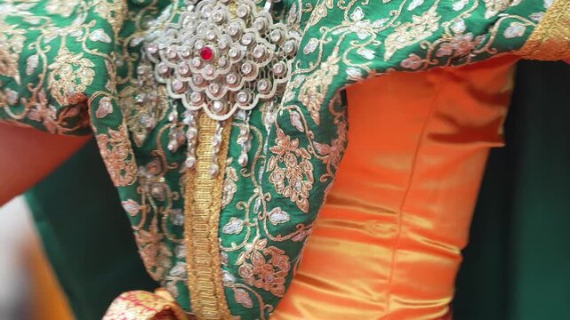 Traditional Thai dance close perspective focusing on expressive hand and foot gestures with intricate costume details and cultural performance style.