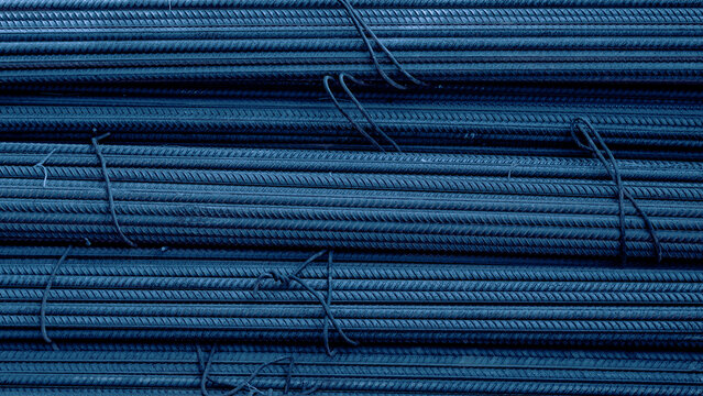 Steel rebar bundles stacked together in construction site storage area