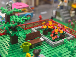 Obraz premium Lego miniature park with bench and colorful flower bed