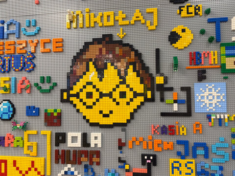 Lego pixel-art smiling character mural