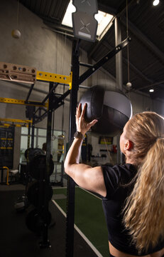 Fitness and health concept. A fit young woman works out in a modern gym. Athletic man doing exercise.