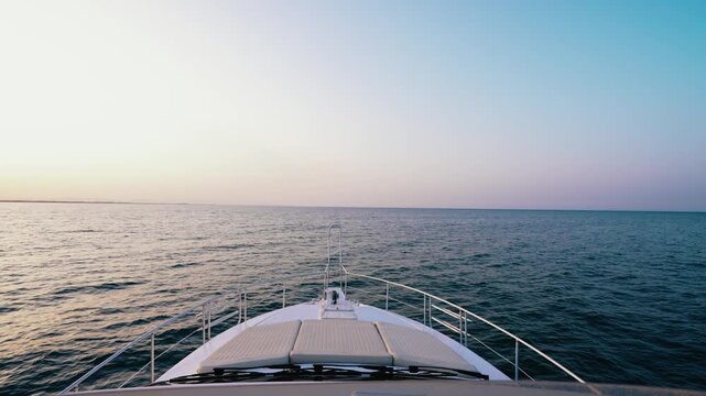Luxury Yacht Bow with Sunbeds Facing Infinite Open Sea at Pastel Sunset