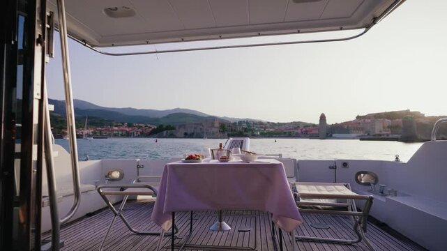 Luxury Yacht Dining Experience Facing Collioure Church and Castle at Sunset