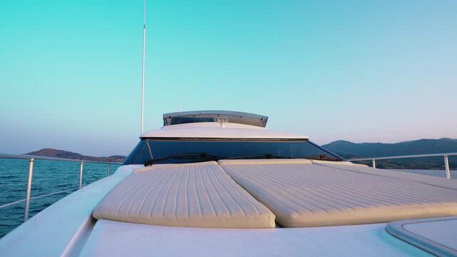 Luxury Yacht Front Deck with Sun Loungers and Mediterranean Sea at Dusk