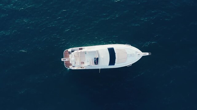 Top Down Aerial View of Luxury Yacht with Teak Deck on Deep Blue Water