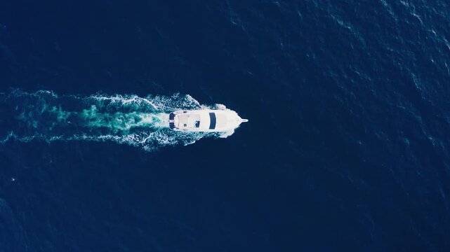 Aerial Top View of White Motorboat Speeding on Deep Blue Sea